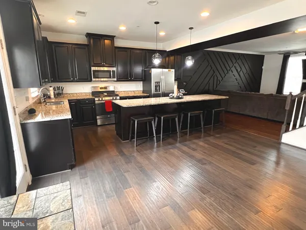 a kitchen with lots of counter space a sink appliances and cabinets