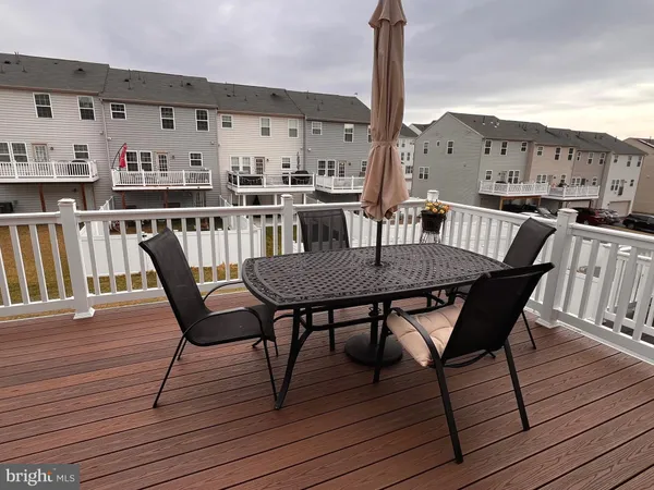 a view of a roof deck with table and chairs
