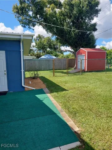 a view of house with a yard