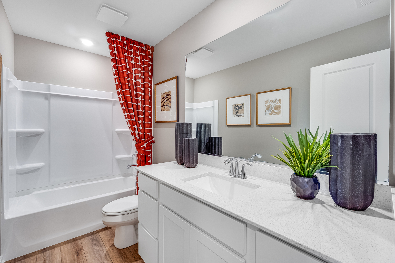 401 Cold Springs Street Cary, IL 60102 - Photo 16 of 20 a bathroom with a potted plant on the counter and a shower
