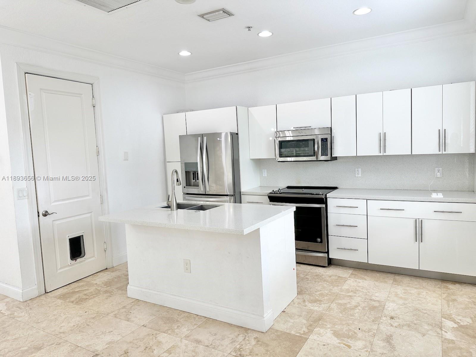 813 Southeast 18th Court Fort Lauderdale, FL 33316 - Photo 12 of 43 a kitchen with stainless steel appliances granite countertop a stove a sink and a refrigerator