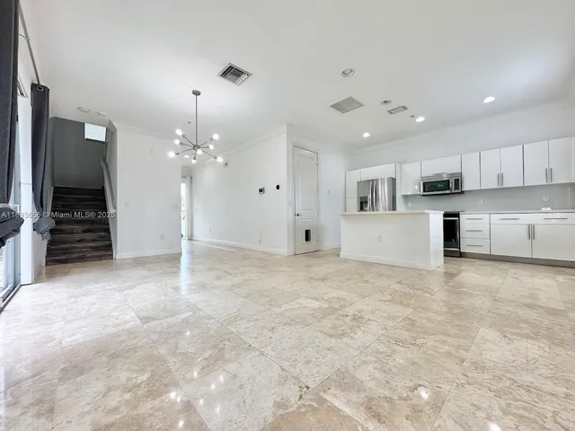a bathroom with a granite countertop sink a toilet and shower