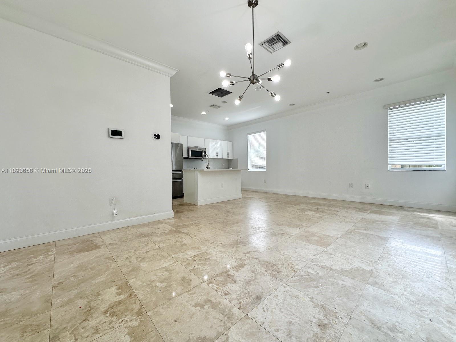 813 Southeast 18th Court Fort Lauderdale, FL 33316 - Photo 16 of 43 a view of a kitchen with a stove cabinets and a ceiling fan