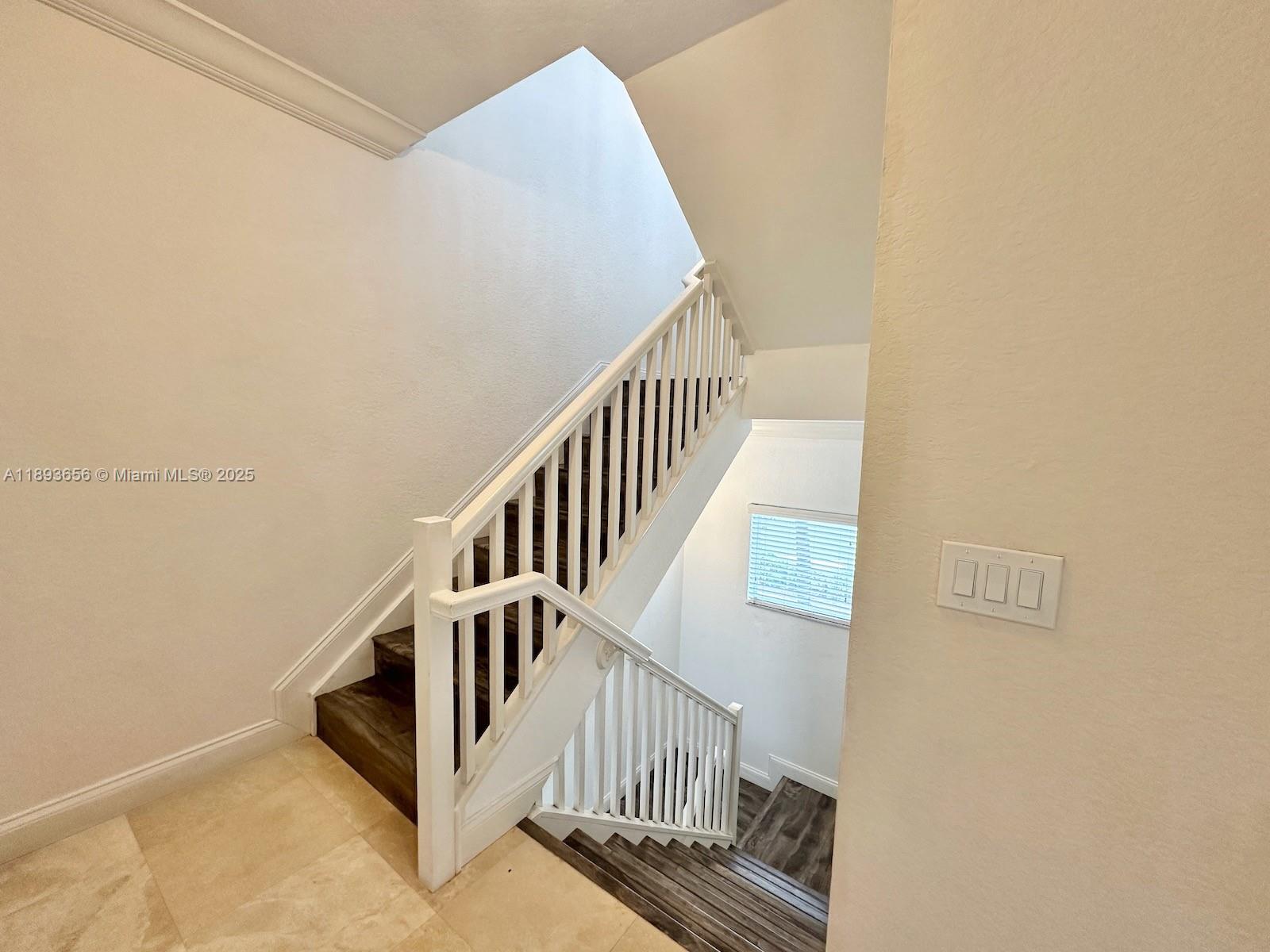 813 Southeast 18th Court Fort Lauderdale, FL 33316 - Photo 22 of 43 a view of staircase with white walls and a window