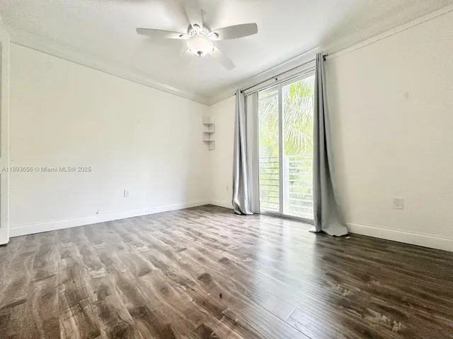 a view of a room with wooden floor and white walls