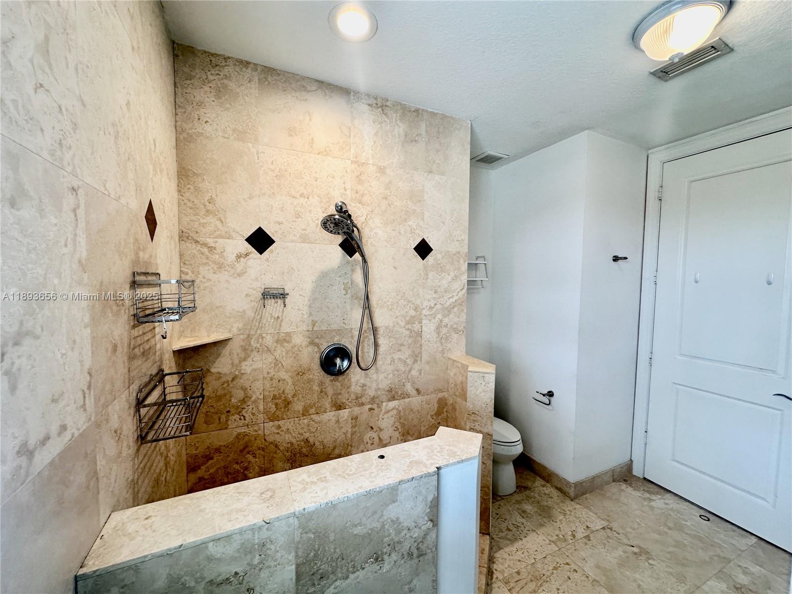 813 Southeast 18th Court Fort Lauderdale, FL 33316 - Photo 28 of 43 a bathroom with a granite countertop sink a toilet and shower