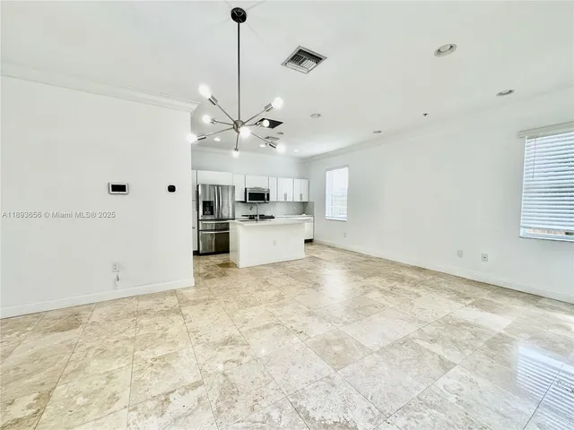 a view of a kitchen with a stove cabinets and a ceiling fan