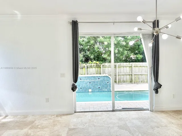 a view of staircase with white walls and a window