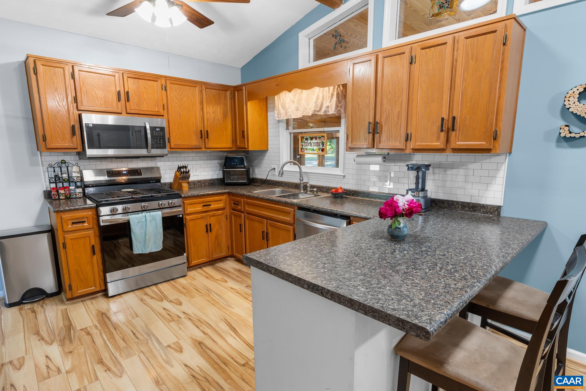 1971 Wilderness Road Reva, VA 22735 - Photo 11 of 47 a kitchen with stainless steel appliances granite countertop a sink window and cabinets