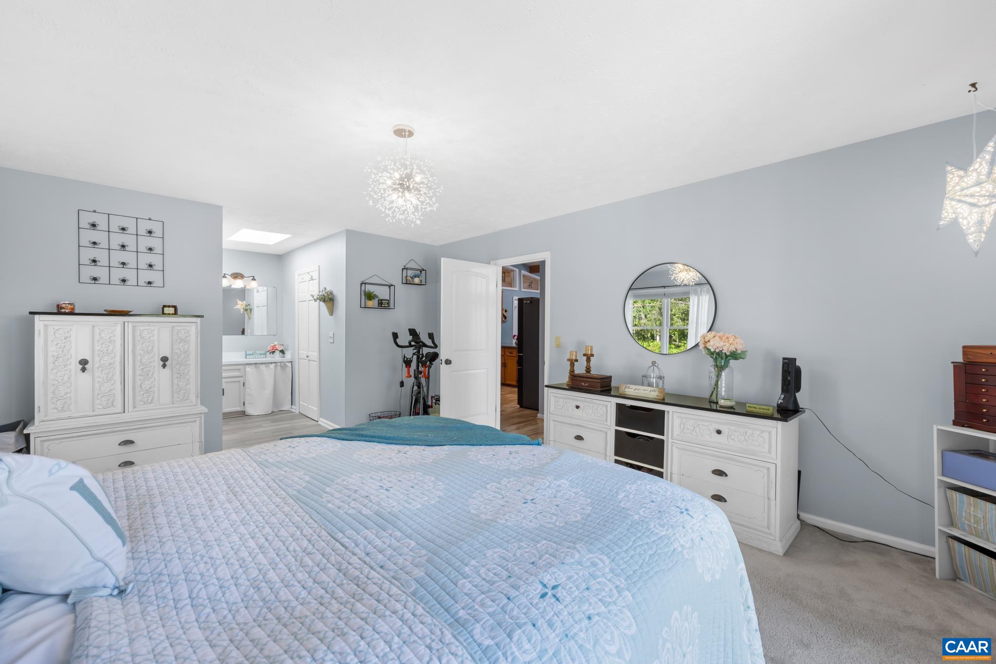 1971 Wilderness Road Reva, VA 22735 - Photo 21 of 47 a spacious bedroom with a bed and a chandelier