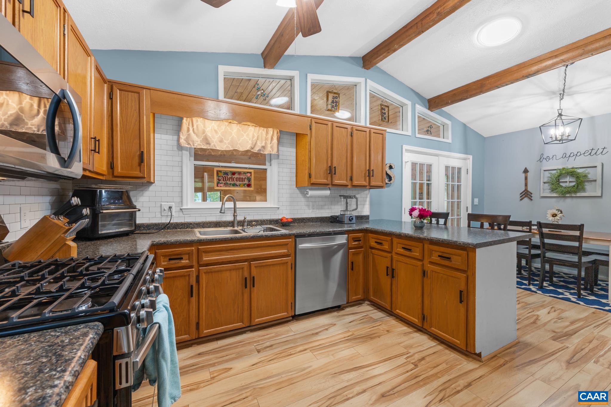 1971 Wilderness Road Reva, VA 22735 - Photo 9 of 47 a kitchen with stainless steel appliances granite countertop wooden cabinets a sink dishwasher a stove and a refrigerator with wooden floor