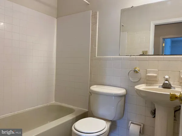 a white toilet sitting next to a bathroom sink
