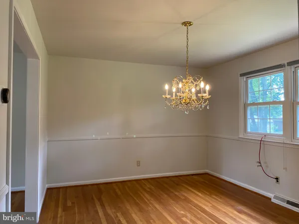 a view of a room with wooden floor and window