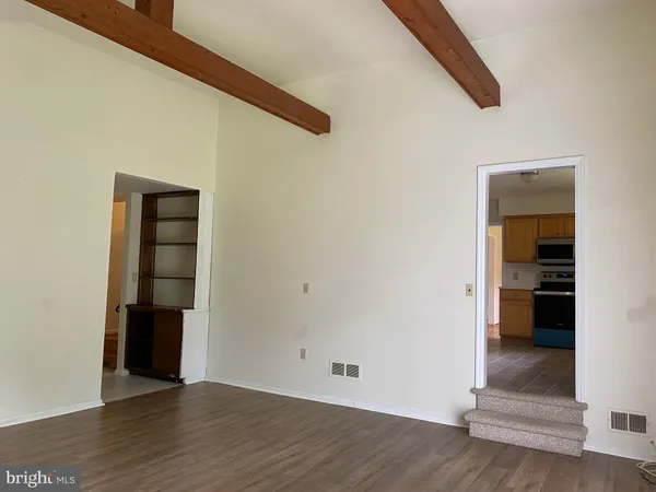 an empty room with wooden floor and closet