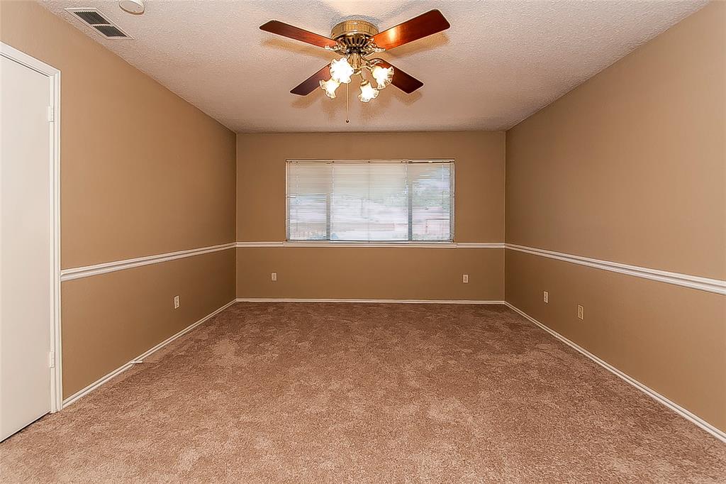 1004 Ledgemont Drive Plano, TX 75025 - Photo 16 of 29 an empty room with windows and fan