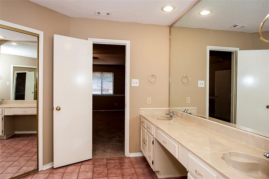 1004 Ledgemont Drive Plano, TX 75025 - Photo 17 of 29 a bathroom with a sink and a mirror