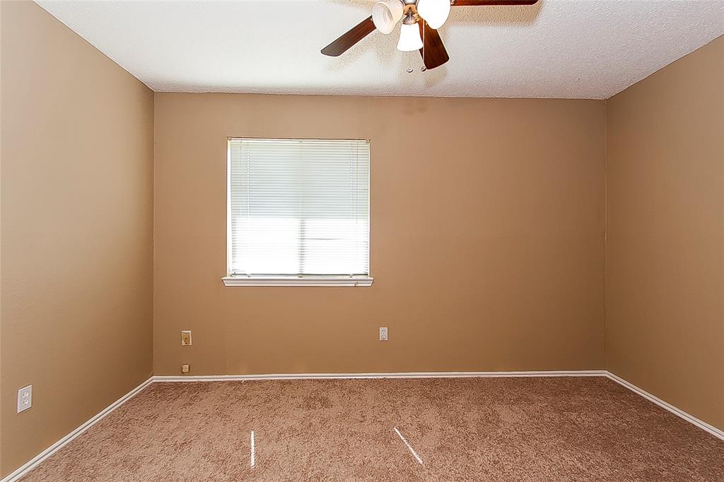 1004 Ledgemont Drive Plano, TX 75025 - Photo 22 of 29 an empty room with a window and a ceiling fan