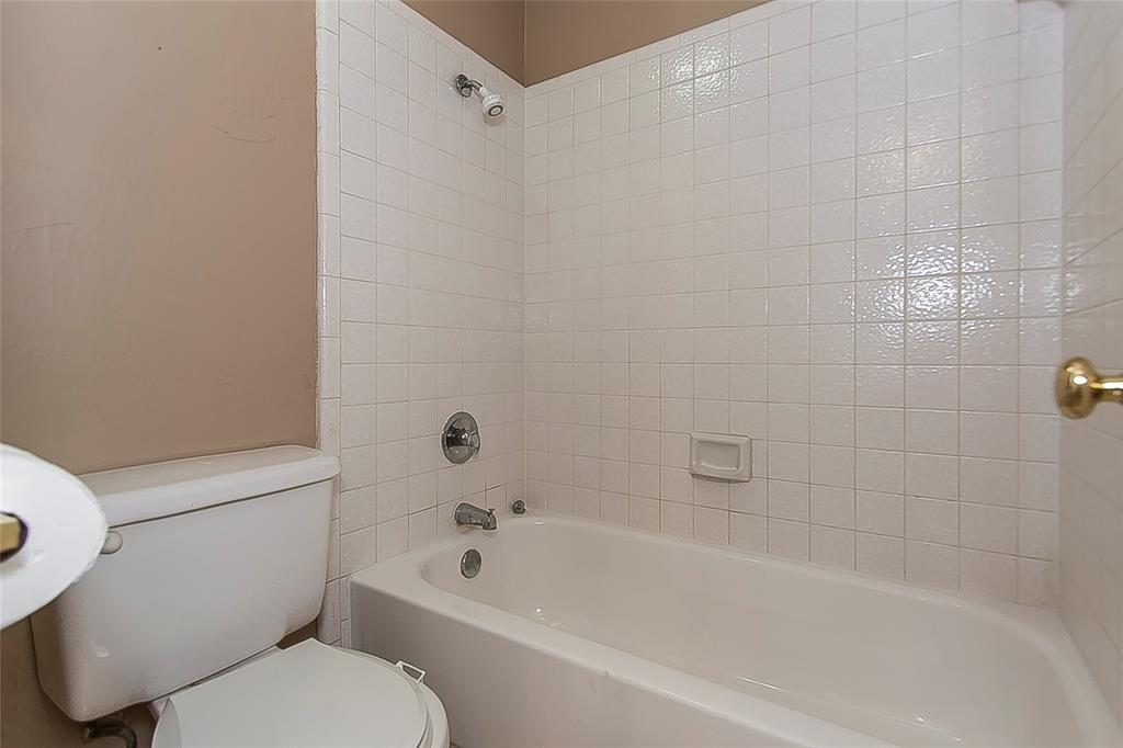 1004 Ledgemont Drive Plano, TX 75025 - Photo 25 of 29 a white bath tub sitting next to a white toilet and sink