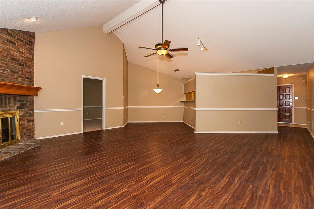 1004 Ledgemont Drive Plano, TX 75025 - Photo 6 of 29 a view of a livingroom with wooden floor and a ceiling fan