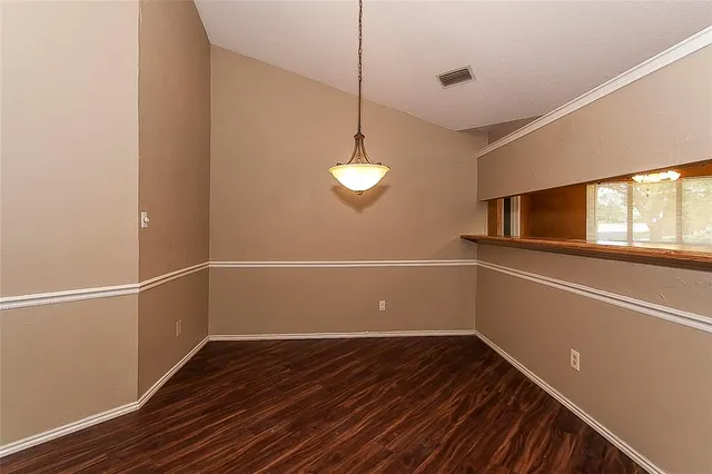 a view of a room with wooden floor and windows
