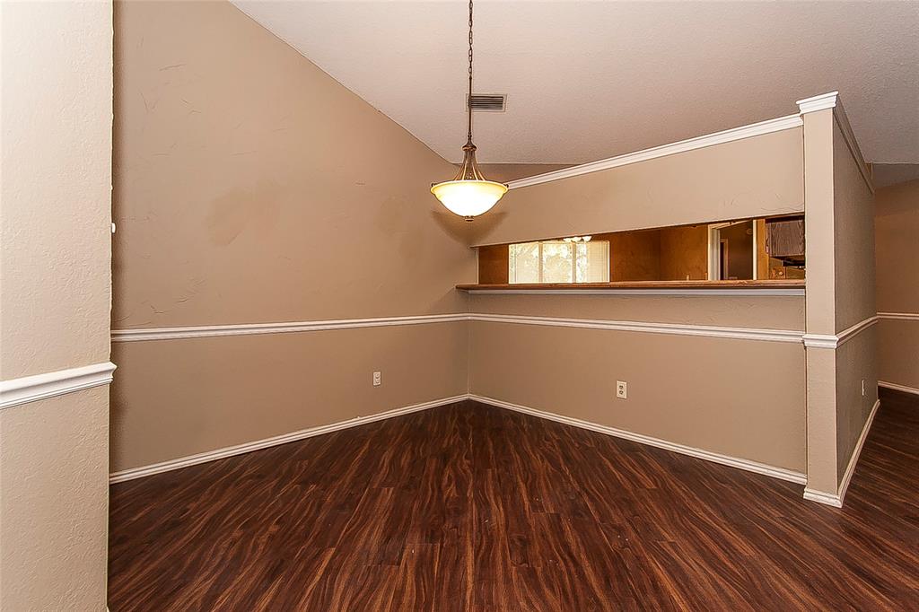 1004 Ledgemont Drive Plano, TX 75025 - Photo 8 of 29 a view of a room with wooden floor and white walls
