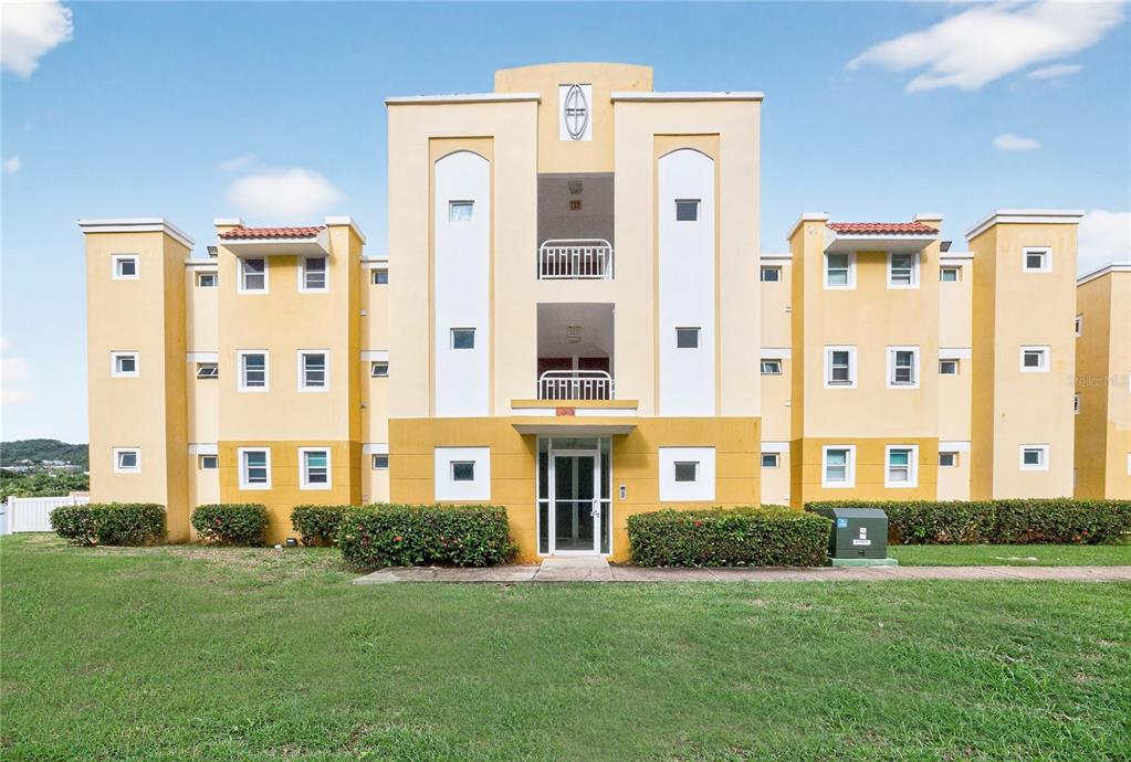 3 Castillos Del Mar, Unit CB2 Ceiba, PR 00735 - Photo 1 of 1 a front view of a building with a garden