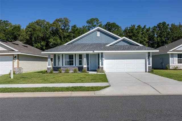 a front view of a house with a garden