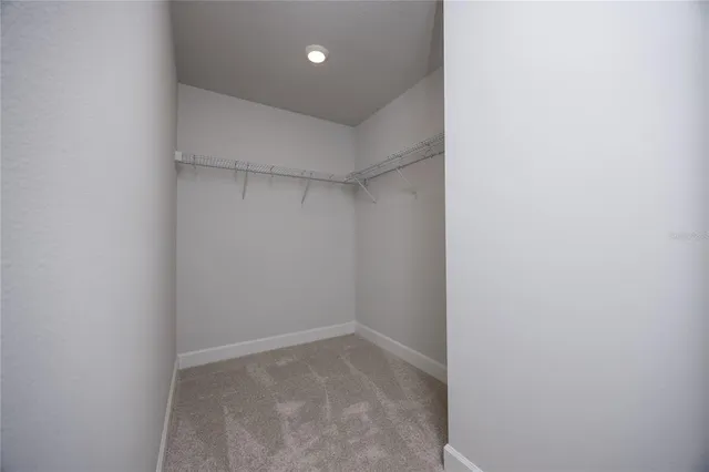 a bathroom with a granite countertop double vanity sink and a mirror