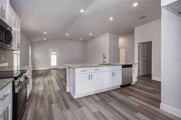 a bathroom with a granite countertop double vanity sink and mirror