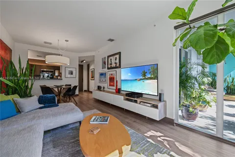 a living room with furniture and a potted plant