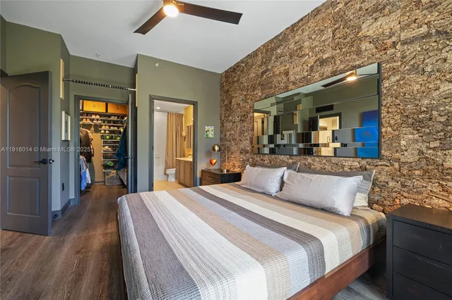 a bedroom with a large bed and wooden floor