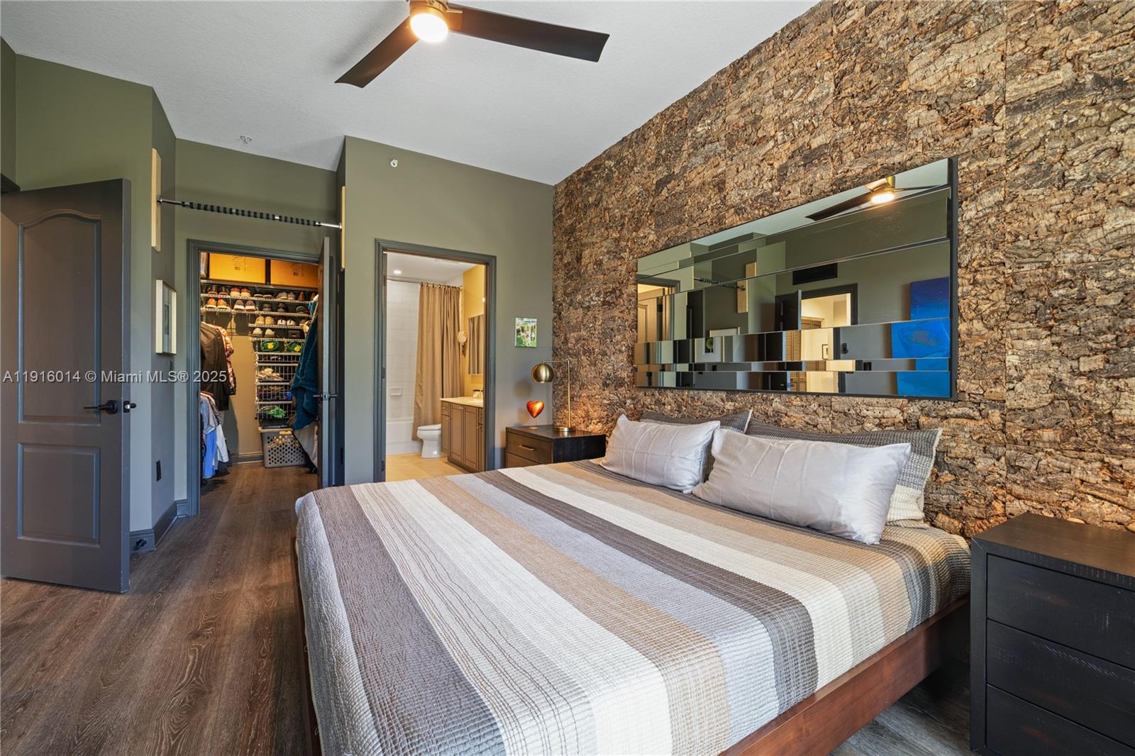 652 Northeast 63rd Street, Unit 403 Miami, FL 33138 - Photo 13 of 28 a bedroom with a large bed and wooden floor