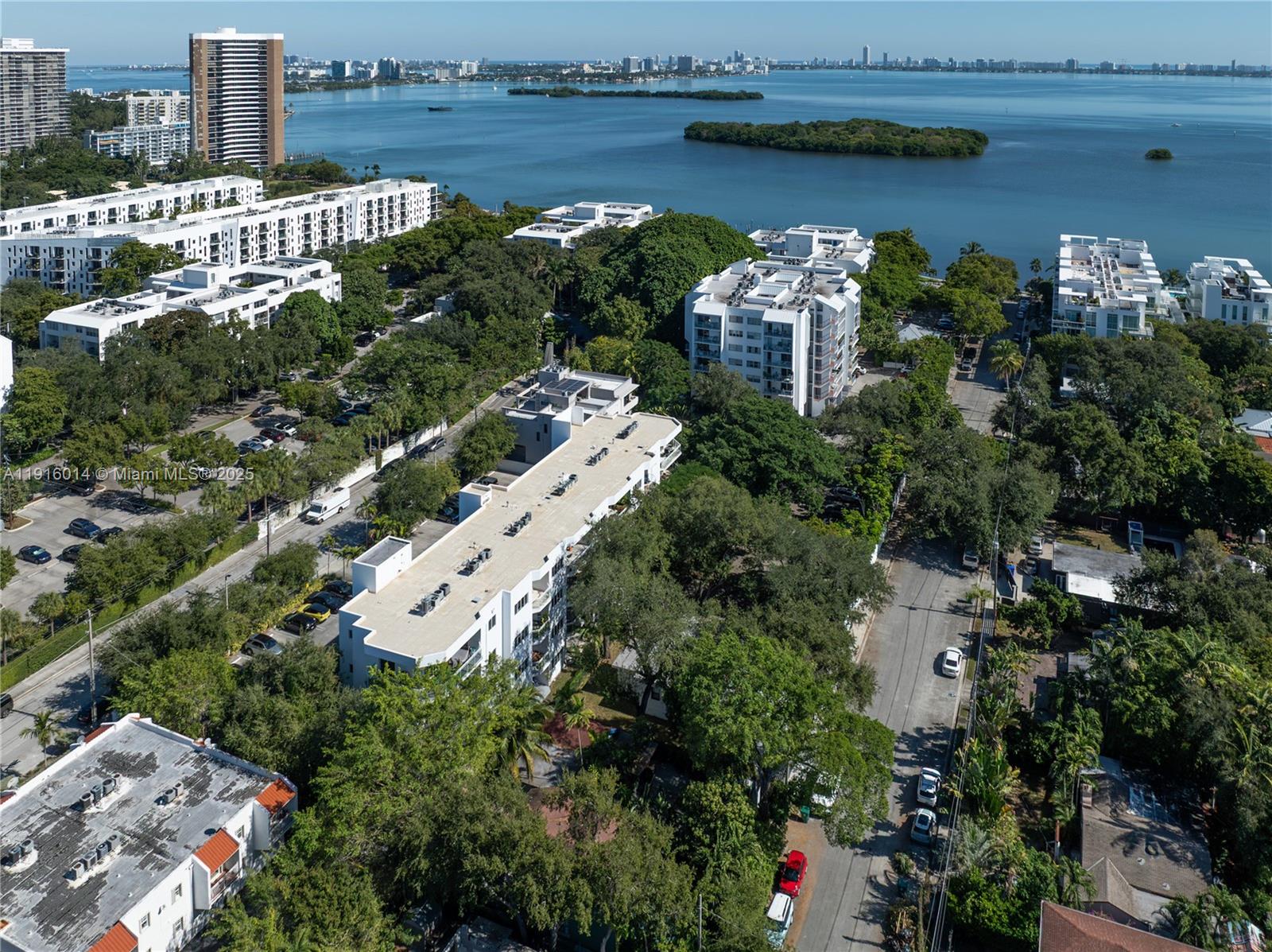 652 Northeast 63rd Street, Unit 403 Miami, FL 33138 - Photo 23 of 28 an aerial view of a house with a garden and lake view