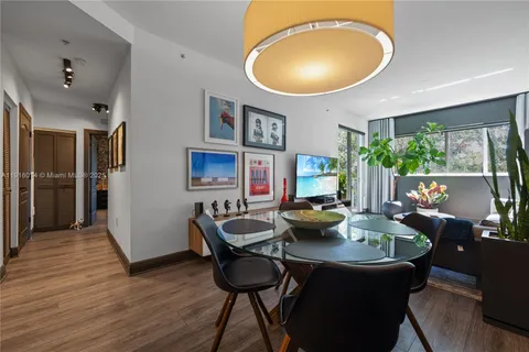 a view of a dining room with furniture and a chandelier