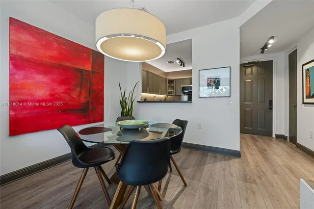 a dining room with furniture and wooden floor