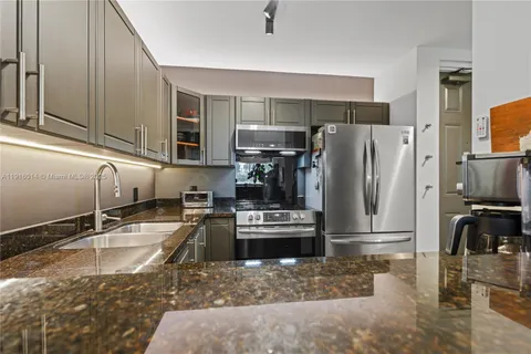 a kitchen with a refrigerator sink and stove