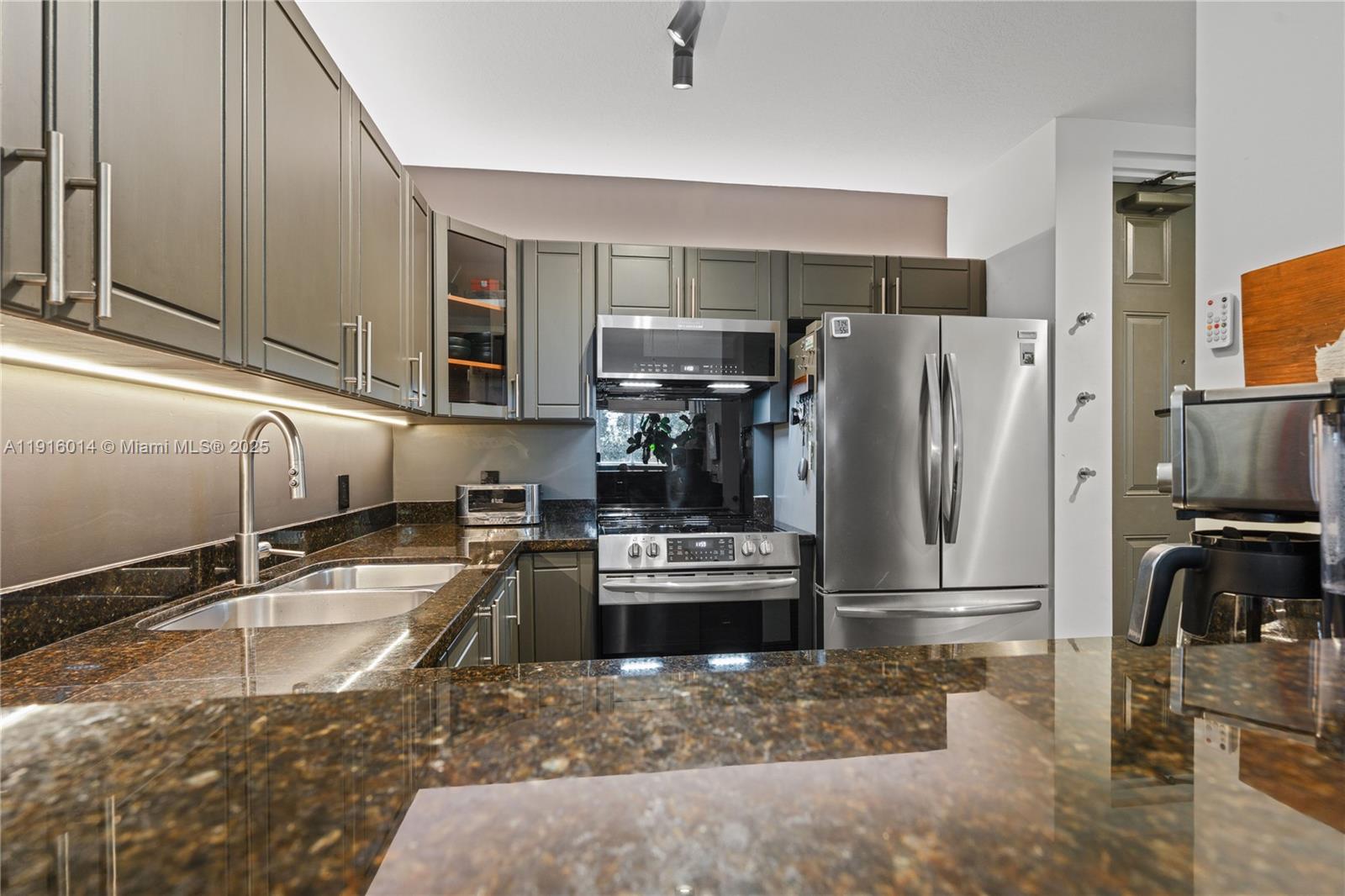 652 Northeast 63rd Street, Unit 403 Miami, FL 33138 - Photo 8 of 28 a kitchen with a refrigerator sink and stove