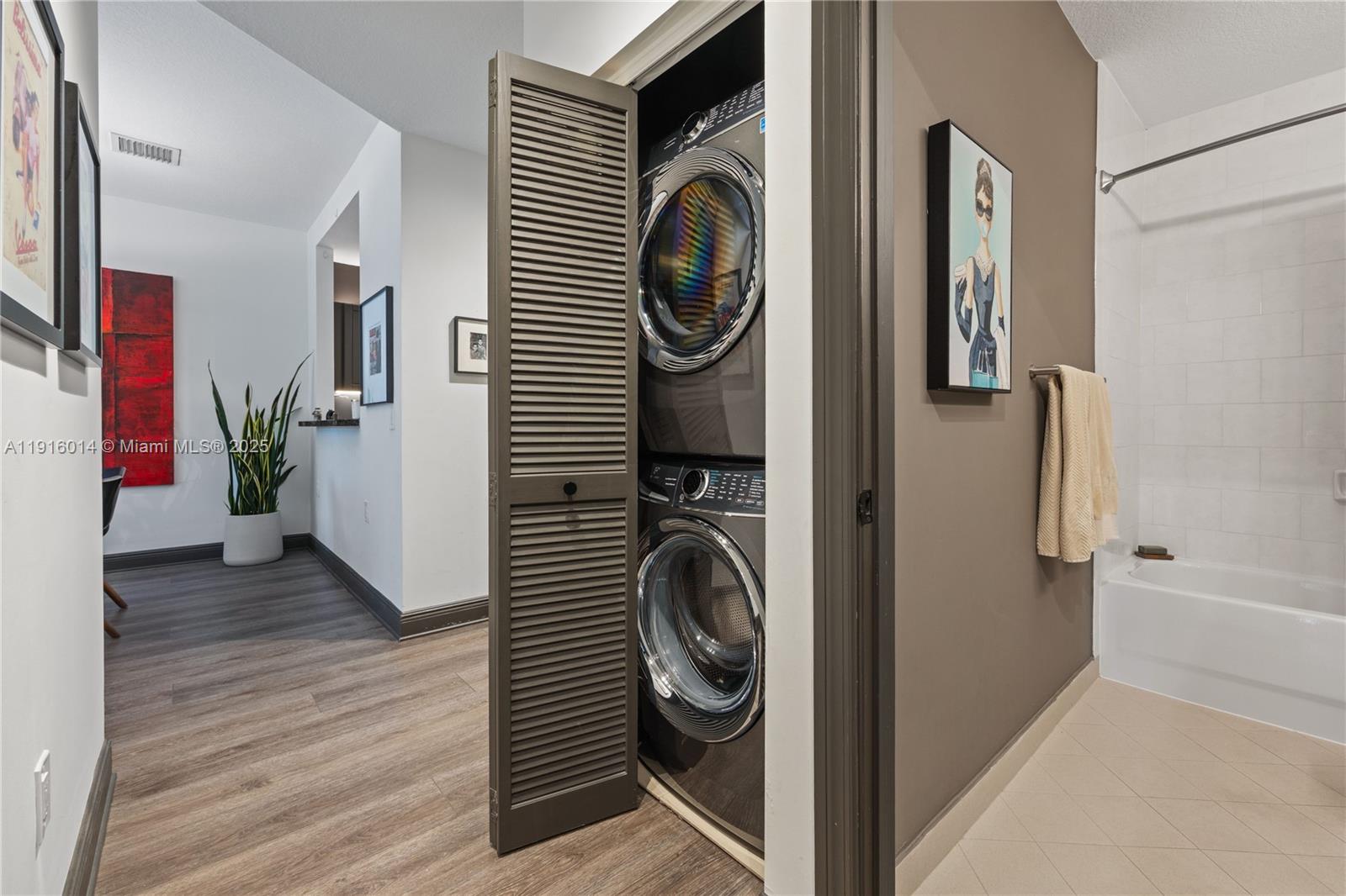 652 Northeast 63rd Street, Unit 403 Miami, FL 33138 - Photo 10 of 28 a view of a hallway with washer and dryer