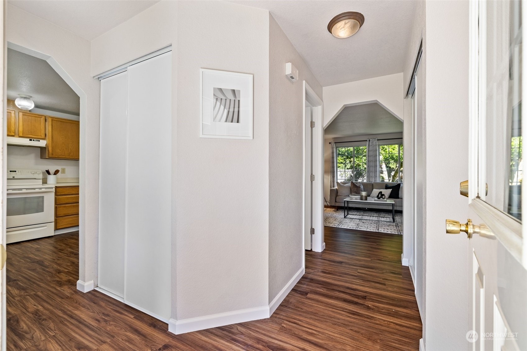 3017 166th Place Southeast Bothell, WA 98012 - Photo 8 of 28 a view of a hallway with wooden floor and a living room
