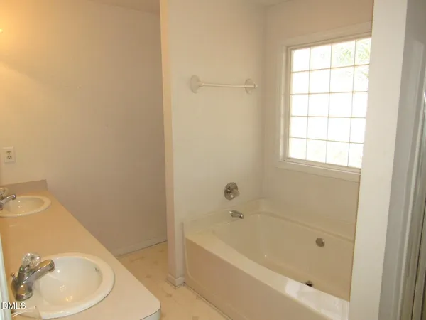 a bathroom with a bathtub and a sink