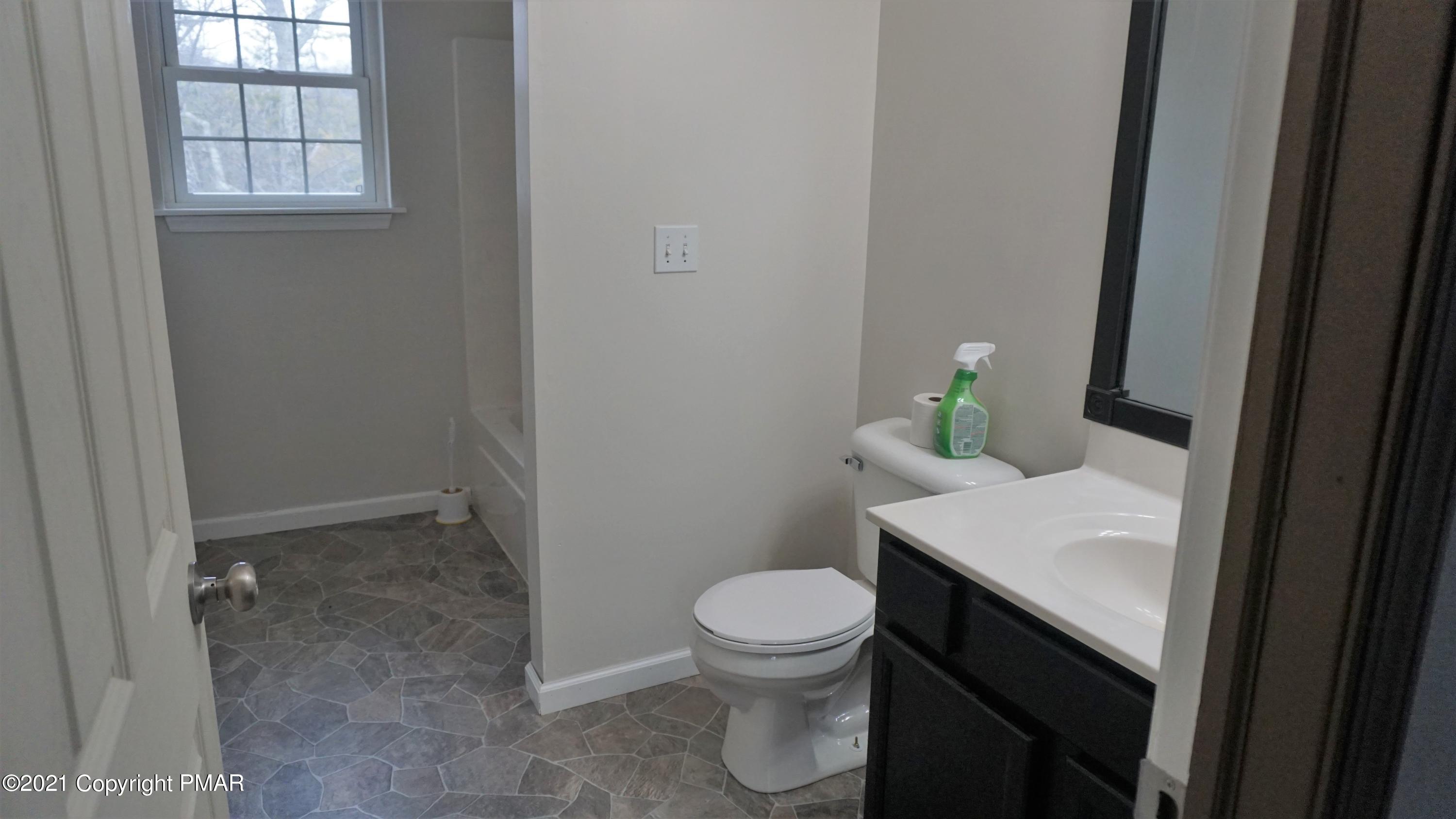 398 Gold Finch Road Bushkill, PA 18324 - Photo 19 of 24 a bathroom with a sink a toilet and a window