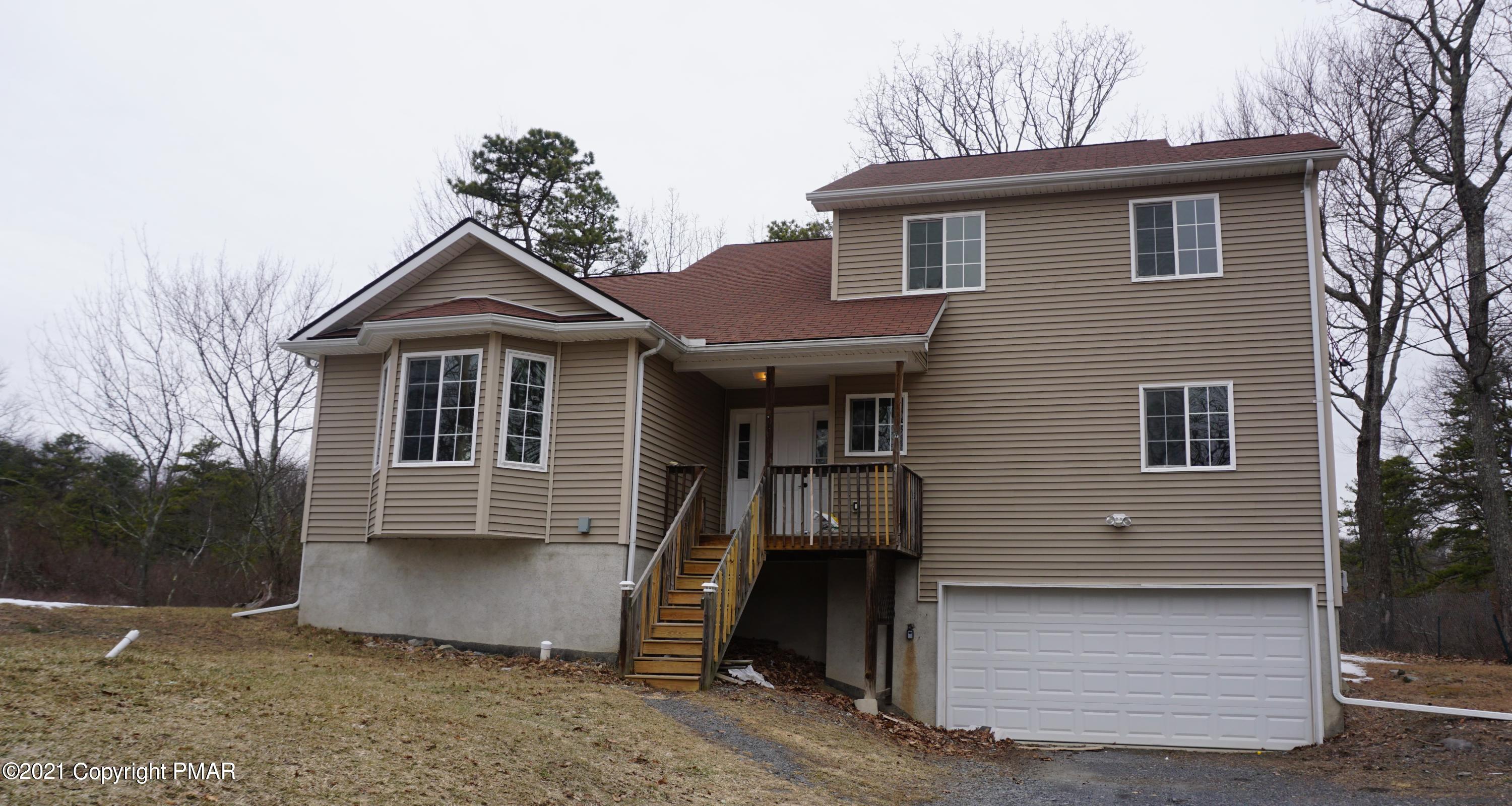 398 Gold Finch Road Bushkill, PA 18324 - Photo 2 of 24 a front view of a house with a yard