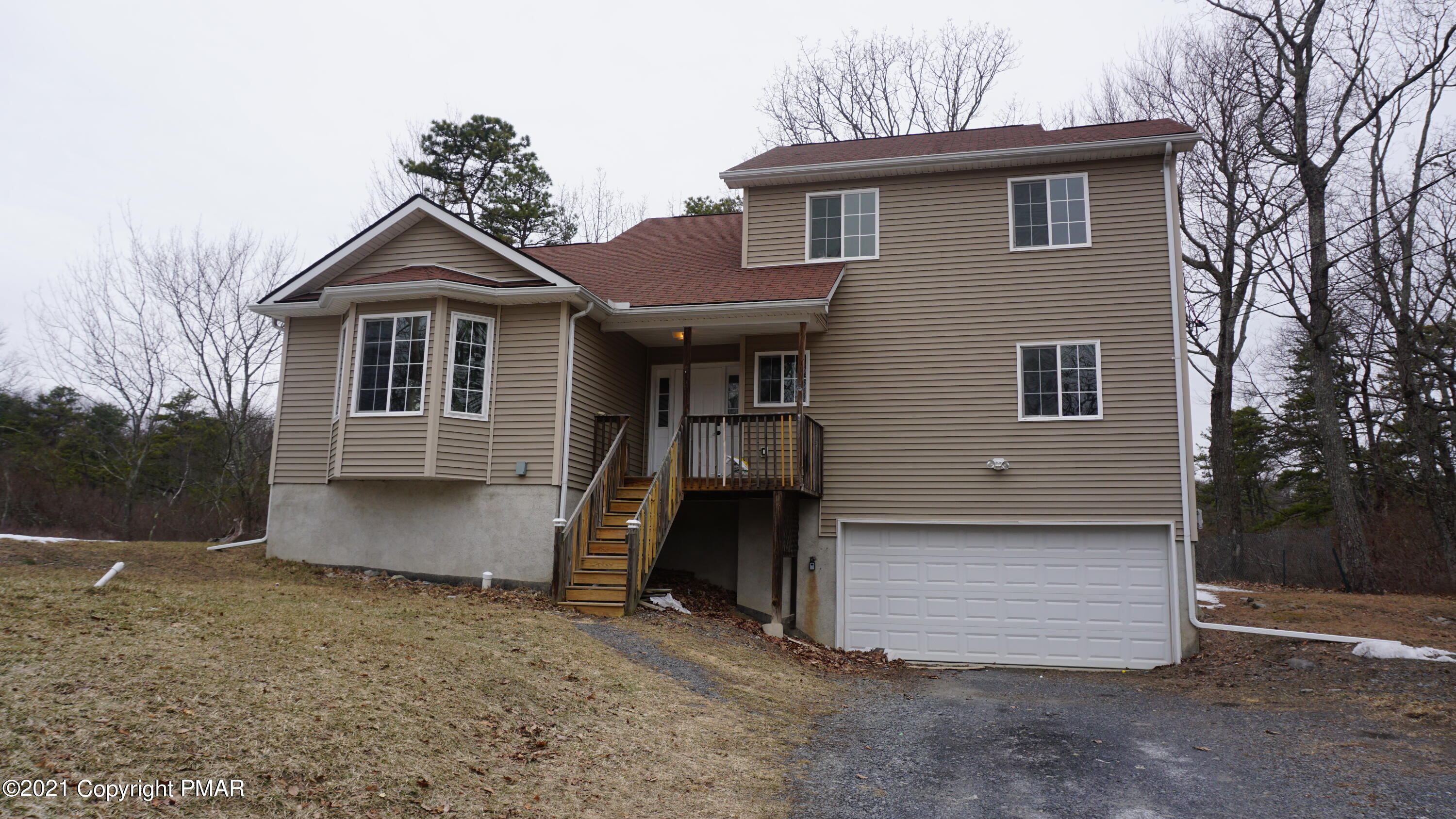 398 Gold Finch Road Bushkill, PA 18324 - Photo 3 of 24 a front view of a house with a yard