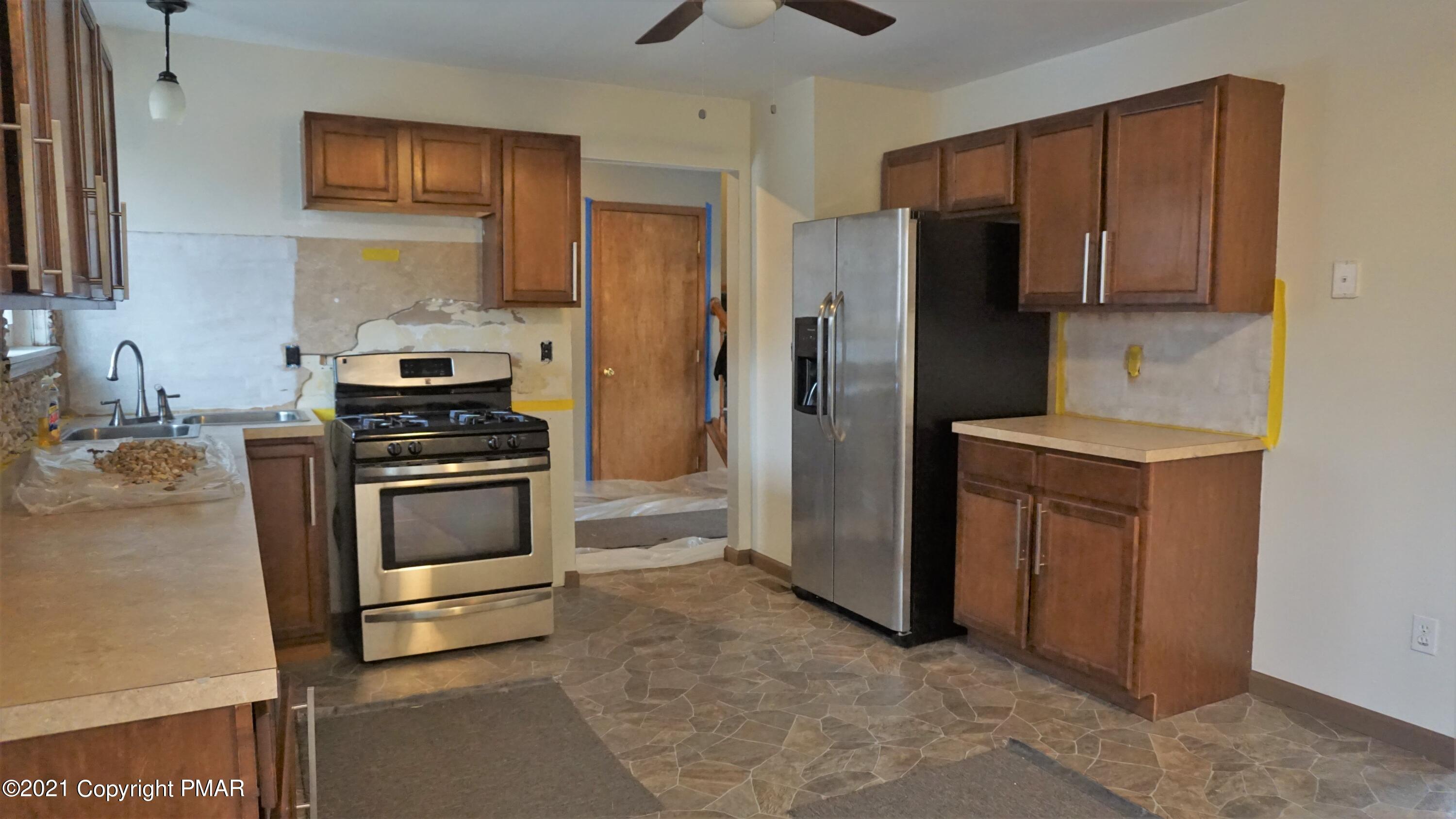 398 Gold Finch Road Bushkill, PA 18324 - Photo 4 of 24 a kitchen with stainless steel appliances a refrigerator stove and sink