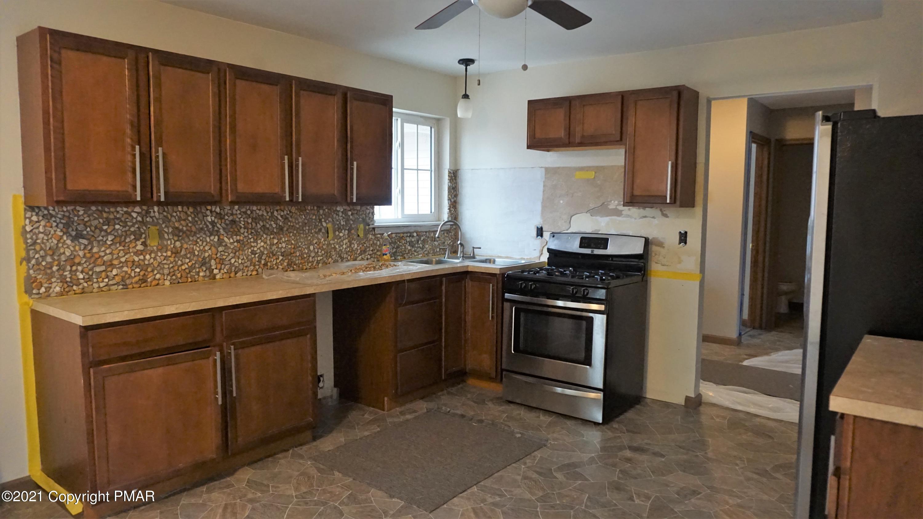 398 Gold Finch Road Bushkill, PA 18324 - Photo 5 of 24 a kitchen with stainless steel appliances granite countertop a stove a sink and a refrigerator