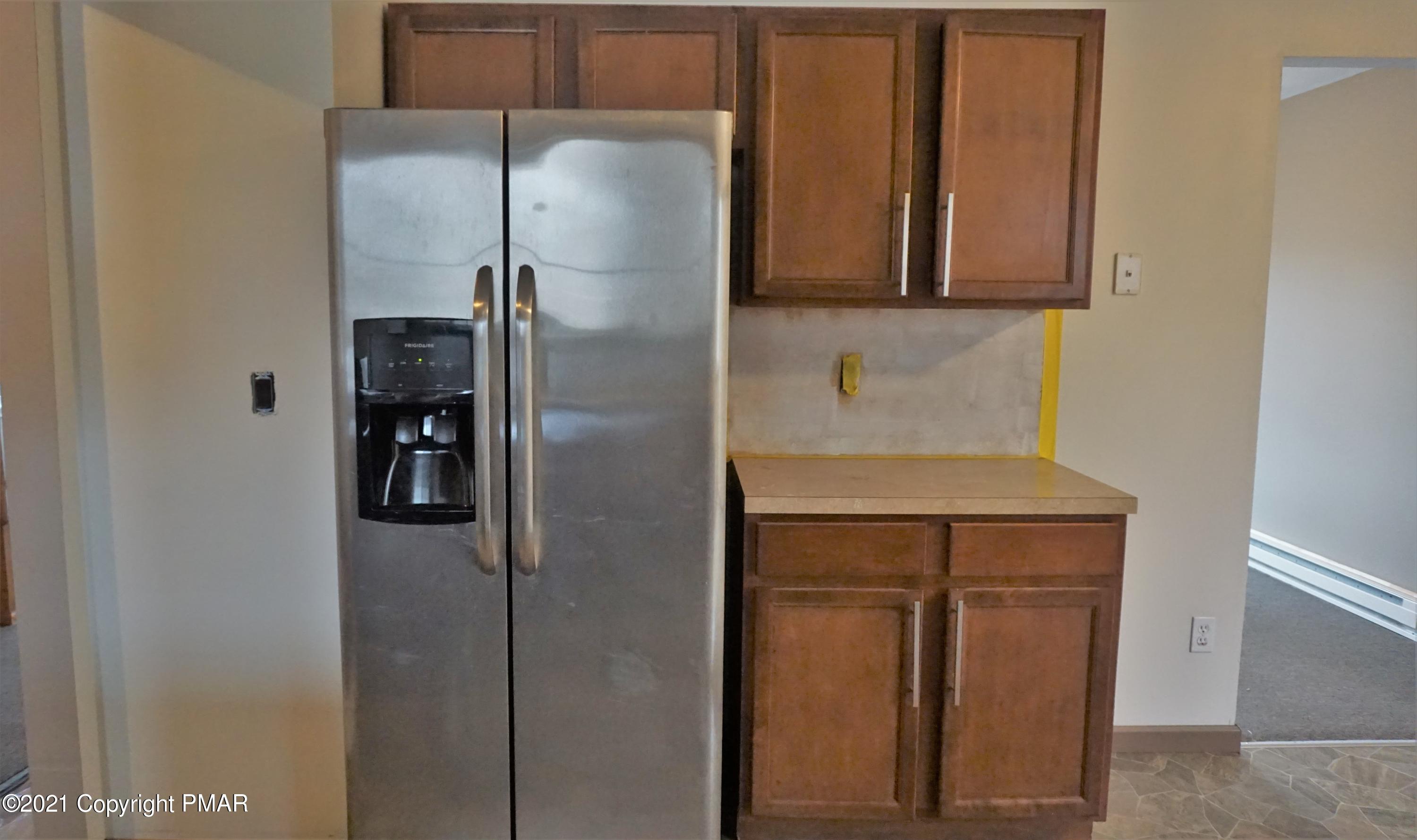 398 Gold Finch Road Bushkill, PA 18324 - Photo 6 of 24 a kitchen with metallic refrigerator freezer and a dishwasher