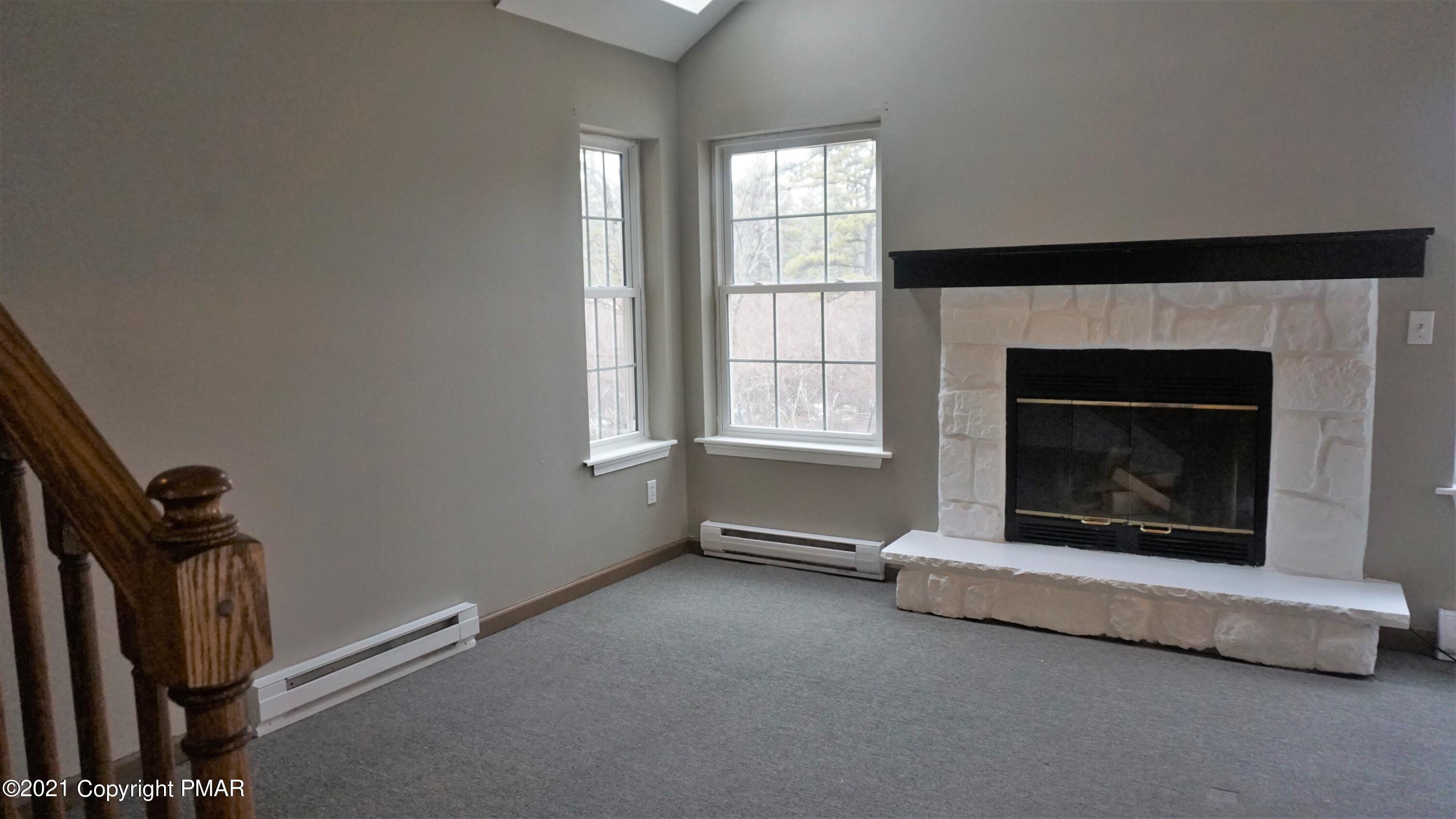398 Gold Finch Road Bushkill, PA 18324 - Photo 8 of 24 a living room with a fireplace and a window
