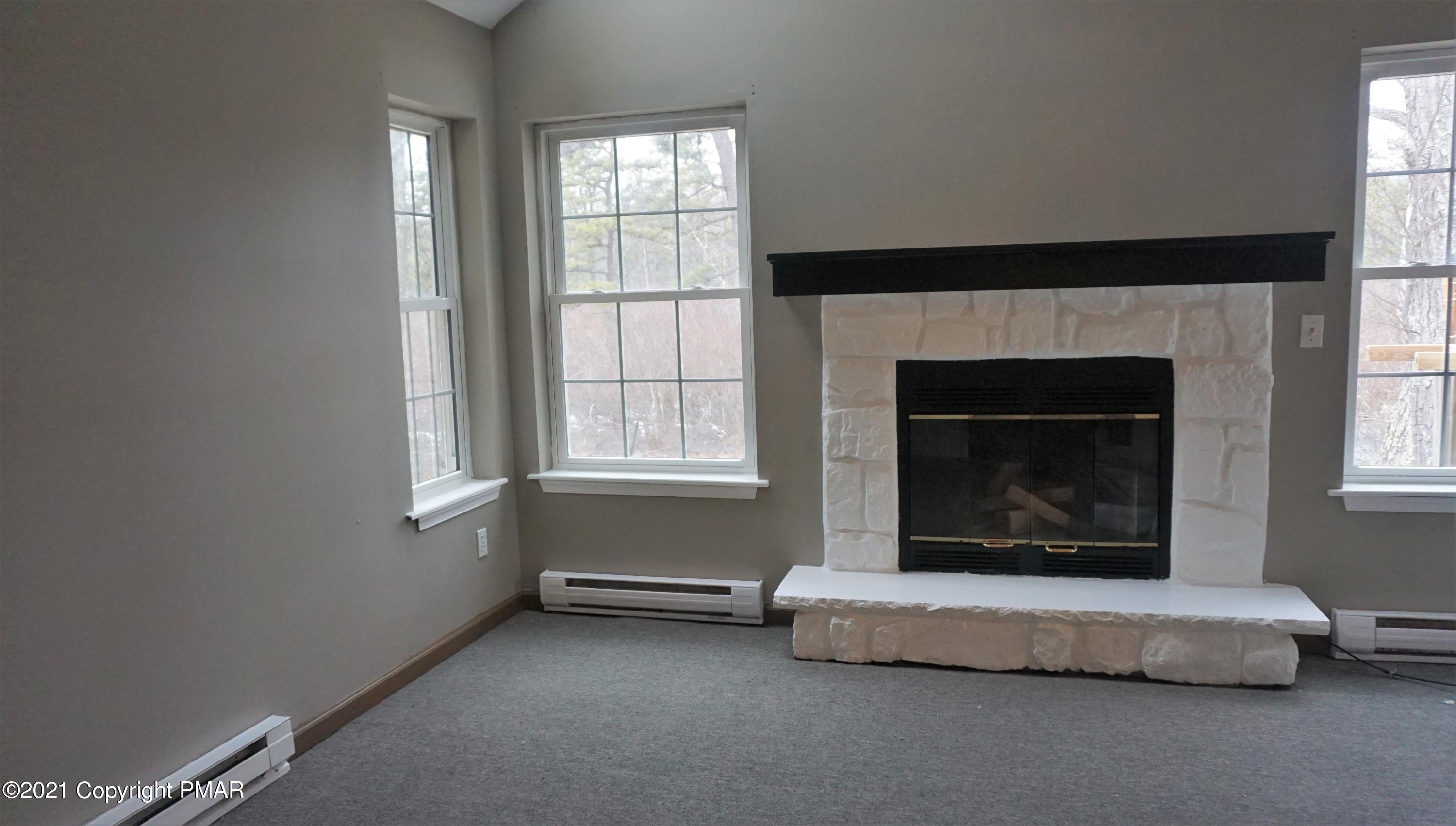 398 Gold Finch Road Bushkill, PA 18324 - Photo 9 of 24 a living room with furniture and a fireplace