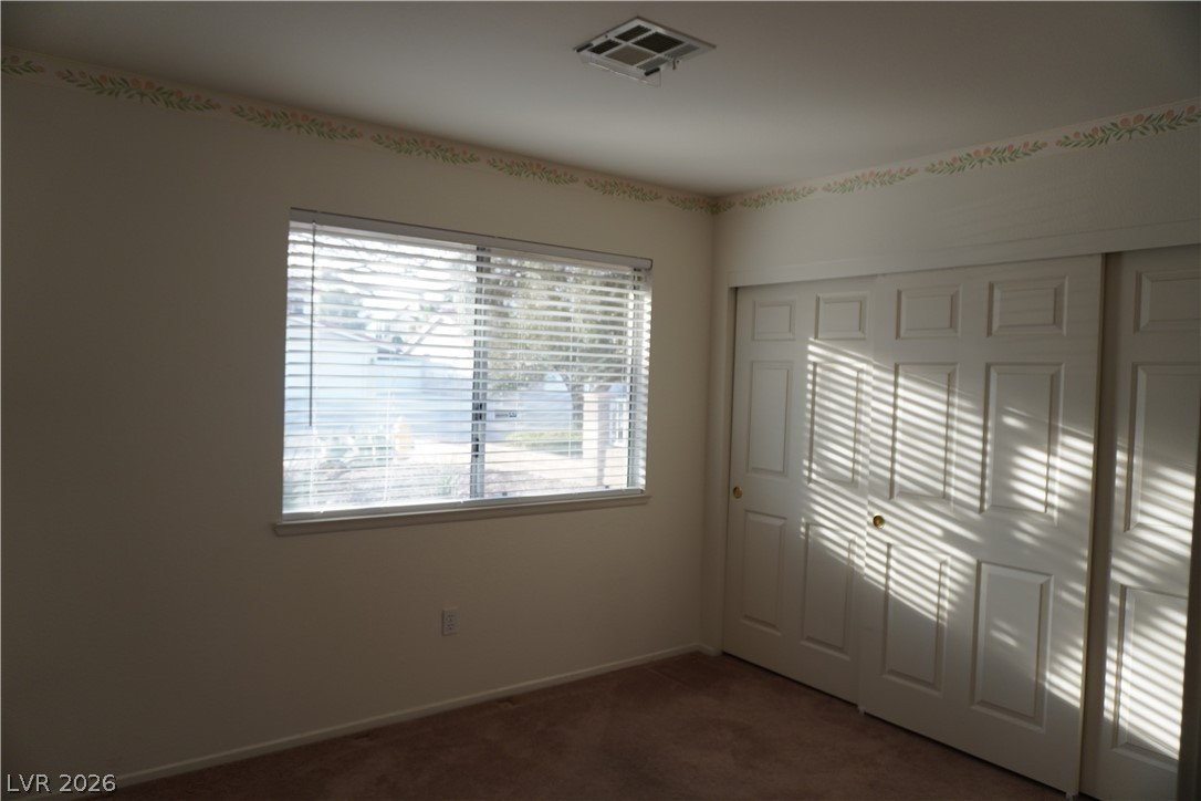 8328 Del Rey Avenue Las Vegas, NV 89117 - Photo 31 of 38 A windowed bedroom with ample closet space.
