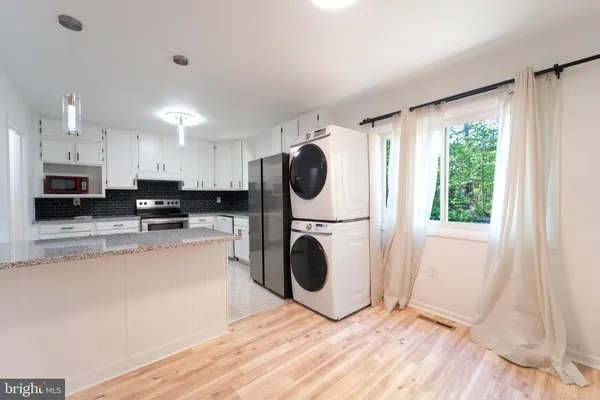 a kitchen with a refrigerator sink and stove